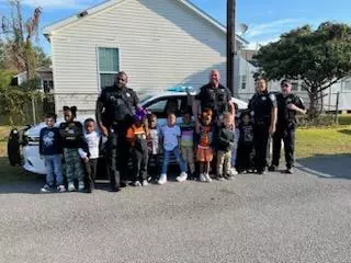 Police with kids by a car