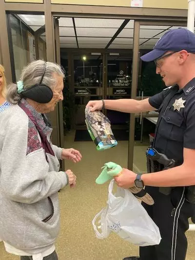 Officer helping lady